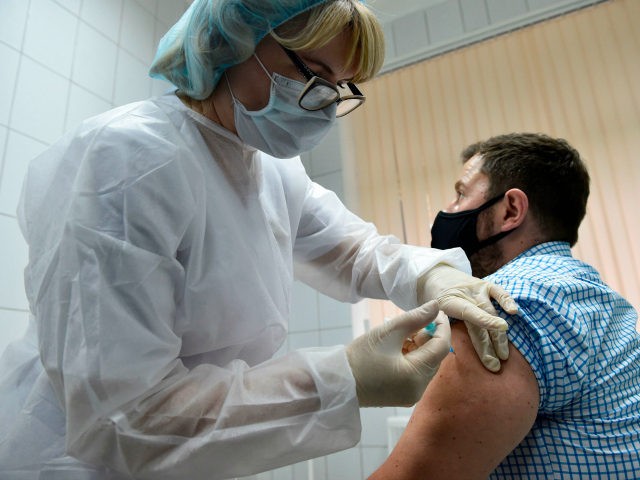 A nurse inoculates volunteer Ilya Dubrovin, 36, with Russia's new coronavirus vaccine in a post-registration trials at a clinic in Moscow on September 10, 2020. - Russia announced last month that its vaccine, named "Sputnik V" after the Soviet-era satellite that was the first launched into space in 1957, had …