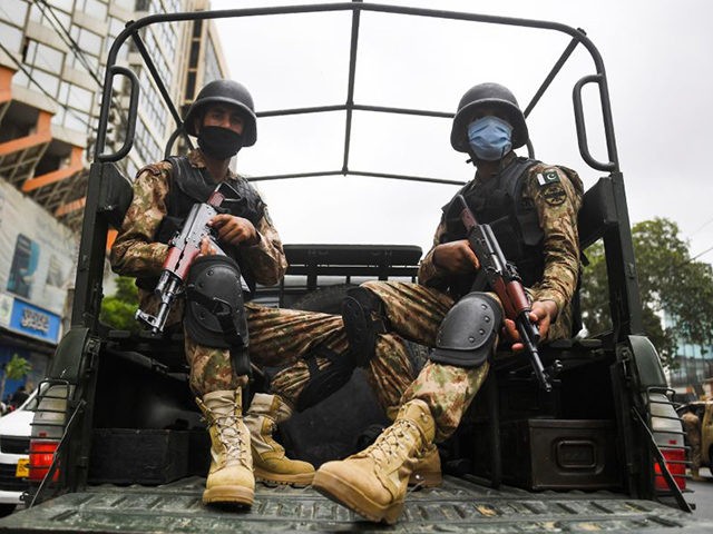 Paramilitary soldiers patrol near the Pakistan Stock Exchange building following an attack by gunmen in Karachi on June 29, 2020. - At least six people were killed when gunmen attacked the Pakistan Stock Exchange in Karachi on June 9, with a policeman among the dead after the assailants opened fire …
