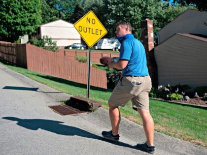 Pennsylvania Republican state representative Tim O'Neal passes a sign as he walks through a neighborhood to meet potential voters in Washington, Pennsylvania on September 4, 2020. - Less than two months before the November 3 presidential election, the contrast between Republicans and Democrats is striking in Washington County, in the …