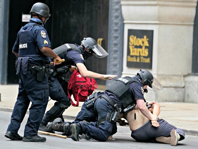 Police detain a man during a protest, Wednesday, Sept. 23, 2020, in Louisville, Ky. A gran