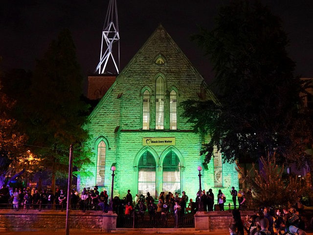 Protesters wait outside the First Unitarian church, Thursday, Sept. 24, 2020, in Louisville, Ky. Authorities pleaded for calm while activists vowed to fight on Thursday in Kentucky's largest city, where a gunman wounded two police officers during anguished protests following the decision not to charge officers for killing Breonna Taylor. …