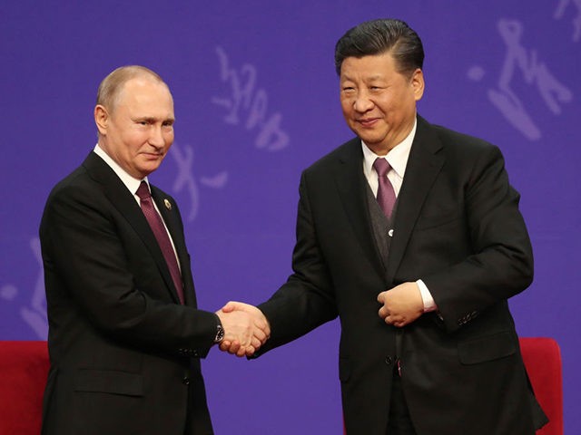 Russian President Vladimir Putin, left, shakes hands with Chinese President Xi Jinping, right, during the Tsinghua Universitys ceremony, at Friendship palace on April 26, 2019 in Beijing, China. (Photo by Kenzaburo Fukuhara - Pool/Getty Images)