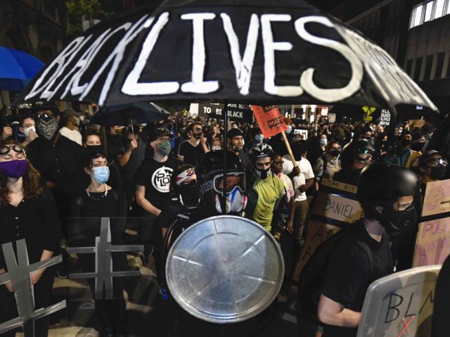 Demonstrators march through the streets in Rochester, N.Y., Friday, Sept. 4, 2020 protesti