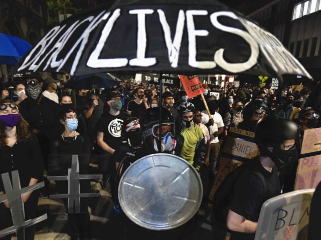 Demonstrators march through the streets in Rochester, N.Y., Friday, Sept. 4, 2020 protesting the death of Daniel Prude. Prude apparently stopped breathing as police in Rochester were restraining him in March 2020 and died when he was taken off life support a week later. (AP Photo/Adrian Kraus)