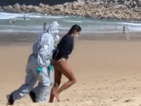 Watch: Lifeguard Led Away in Handcuffs For 'Surfing With Coronavirus'