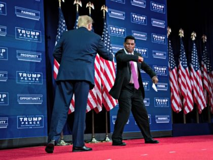 President Donald Trump greets former running back Herschel Walker before speaking at a campaign event at the Cobb Galleria Centre, Friday, Sept. 25, 2020, in Atlanta. (AP Photo/Evan Vucci)