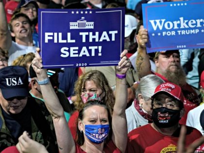 NEWPORT NEWS, VA - SEPTEMBER 25: A woman holds up a "Fill That Seat" sign before