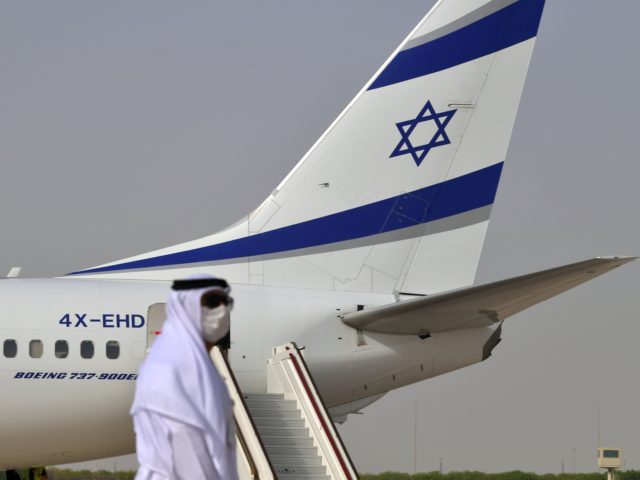 An Emirati official stands near an air-plane of El Al, which carried a US-Israeli delegati