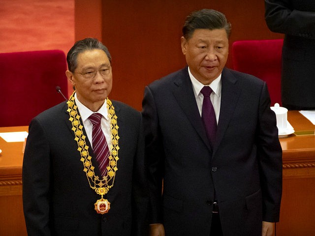 Chinese President Xi Jinping, right, stands with Chinese medical expert Zhong Nanshan afte