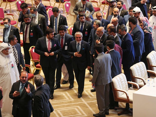 Abdullah Abdullah (C), Chairman of Afghanistan's High Council for National Reconciliation, speaks with members of delegations at the end of the session during the peace talks between the Afghan government and the Taliban in the Qatari capital Doha on September 12, 2020. (Photo by KARIM JAAFAR / AFP) (Photo by …