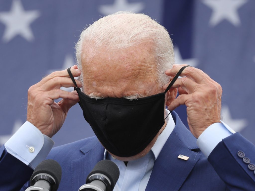 WARREN, MICHIGAN - SEPTEMBER 09: Democratic presidential nominee and former Vice President Joe Biden replaces the mask he wears to reduce the risk posed by coronavirus after addressing union members outside the United Auto Workers Region 1 offices on September 09, 2020 in Warren, Michigan. Biden is campaigning in Michigan, a state President Donald Trump won in 2016 by less than 11,000 votes, the narrowest margin of victory in state's presidential election history. (Photo by Chip Somodevilla/Getty Images)