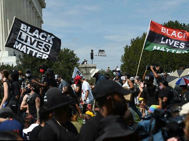 People attend the "Commitment March: Get Your Knee Off Our Necks" protest against racism a