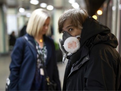 LONDON, ENGLAND - MARCH 23: A Commuters wearing a face protection mask travels on the underground on March 23, 2020 in London, United Kingdom. Coronavirus (COVID-19) pandemic has spread to at least 182 countries, claiming over 10,000 lives and infecting hundreds of thousands more. (Photo by Justin Setterfield/Getty Images)