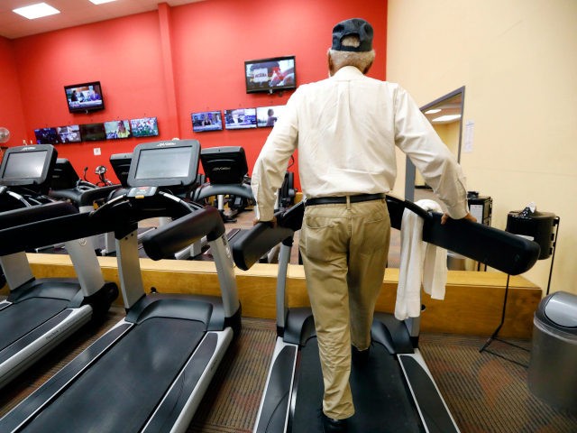 Civil rights movement figure and activist James Meredith, 85, has the option of watching sports or news programs on the wall monitors while he walks on a treadmill at least 30 minutes as part of his morning workout at a fitness center in Flowood, Miss., Thursday, July 19, 2018. Meredith …
