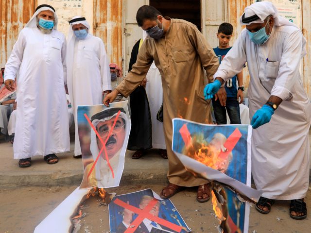 Israel-Bahrain Deal Palestinian men burn the exed out portraits of the Bahraini King, US President and Israeli Premier during a protest in Deir al-Balah, in central Gaza Strip, on September 12, 2020, to condemn the normalisation of ties between Israeli and Bahrain. - The Palestinian cause has long cemented ties …