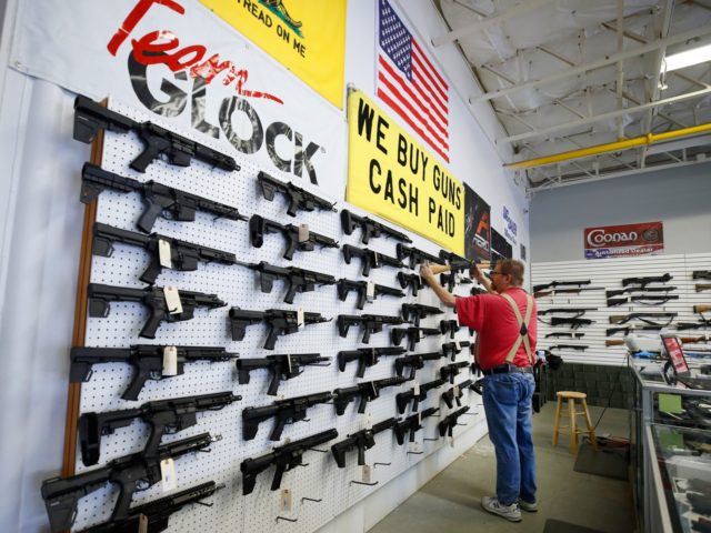 A worker restocks AR-15 guns at Davidson Defense in Orem, Utah on March 20, 2020. - Gun stores in the US are reporting a surge in sales of firearms as coronavirus fears trigger personal safety concerns. (Photo by GEORGE FREY / AFP) (Photo by GEORGE FREY/AFP via Getty Images)