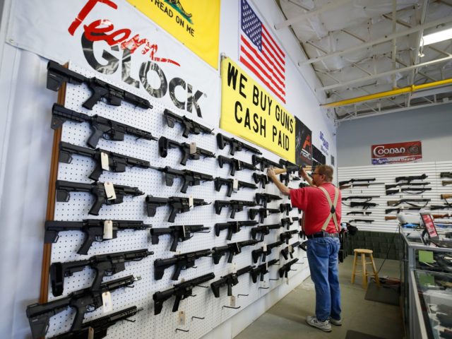 A worker restocks AR-15 guns at Davidson Defense in Orem, Utah on March 20, 2020. - Gun st