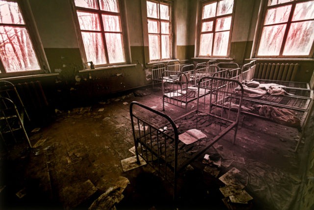 Abandoned psychiatric hospital with beds, fear and interior