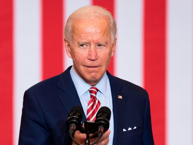 Democratic Presidential Candidate Joe Biden plays music from his cell phone as he particip