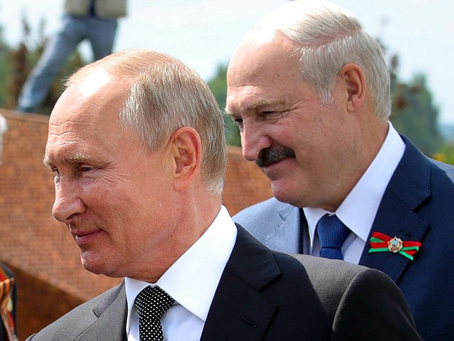FILE - In this June 30, 2020, file photo, Russian President Vladimir Putin, left, and Belarusian President Alexander Lukashenko greet World War II veterans during the opening of a monument in their honor in the village of Khoroshevo, northwest of Moscow, Russia. Lukashenko is beset by protests since his Aug. …