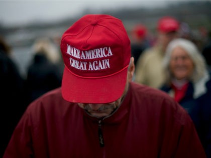 A Trump supporter wears a "MAKE AMERICA GREAT AGAIN" hat while waiting in the rain before U.S. President Donald J. Trump holds a campaign rally on December 10, 2019 in Hershey, Pennsylvania. This rally marks the third time President Trump has held a campaign rally at Giant Center. U.S. Vice …