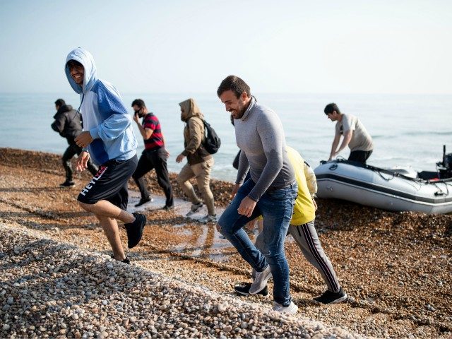 DEAL, ENGLAND - SEPTEMBER 14: Migrants make their way inland after landing on Deal beach a