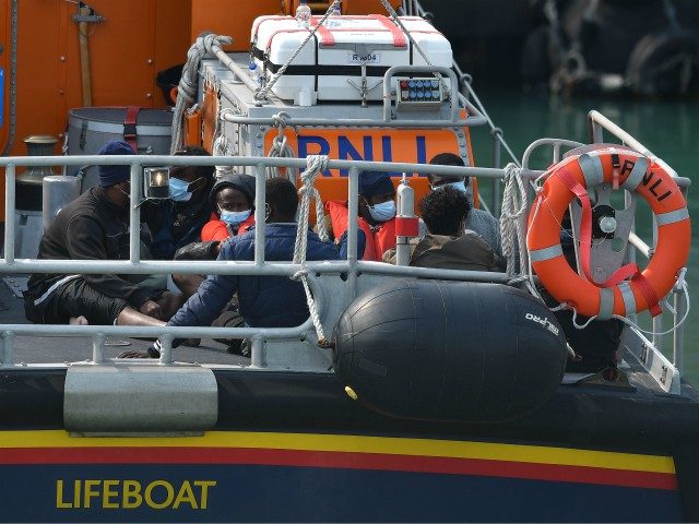 Migrants picked up at sea whilst crossing the English Channel are brought into the Marina in Dover, southeast England on September 11, 2020 on an RNLI lifeboat. - Nearly 1,500 migrants and asylum-seekers arrived in Britain by small boats in the month of August, according to an analysis by the …