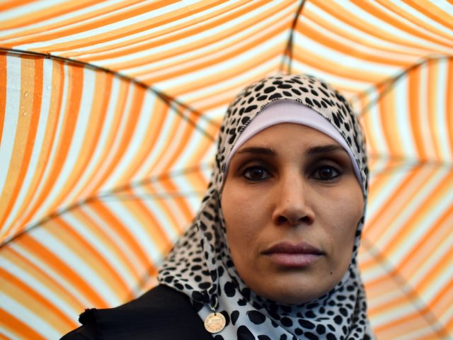 A woman looks on during a demonstration of muslims to speak out against terrorism a week a