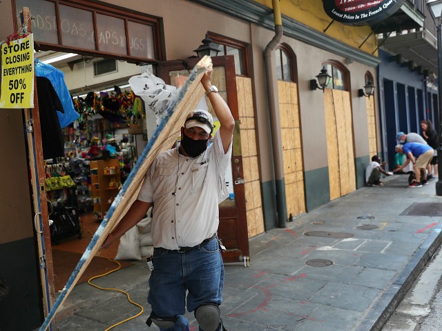 NEW ORLEANS, LOUISIANA - SEPTEMBER 14: Luis A. Sanabria puts plywood over the windows of a business in the historic French Quarter before the possible arrival of Hurricane Sally on September 14, 2020 in New Orleans, Louisiana. The storm is threatening to bring heavy rain, high winds and a dangerous storm surge from Louisiana to Florida. (Photo by Joe Raedle/Getty Images)