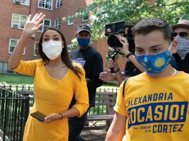 Democratic Rep. Alexandria Ocasio-Cortez, who is running for re-election, waves to support