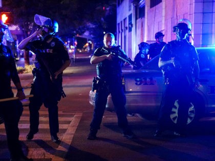 Police stand guard on the perimeter of a crime scene after a police officer was shot, Wednesday, Sept. 23, 2020, in Louisville, Ky. A grand jury has indicted one officer on criminal charges six months after Breonna Taylor was fatally shot by police in Kentucky. The jury presented its decision …