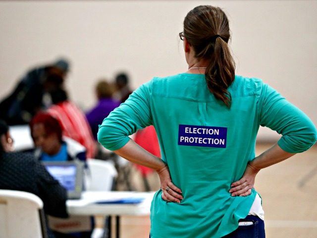 In this Nov. 8, 2016, file photo, poll watcher Jane Grimes Meneely, right, watches as vote