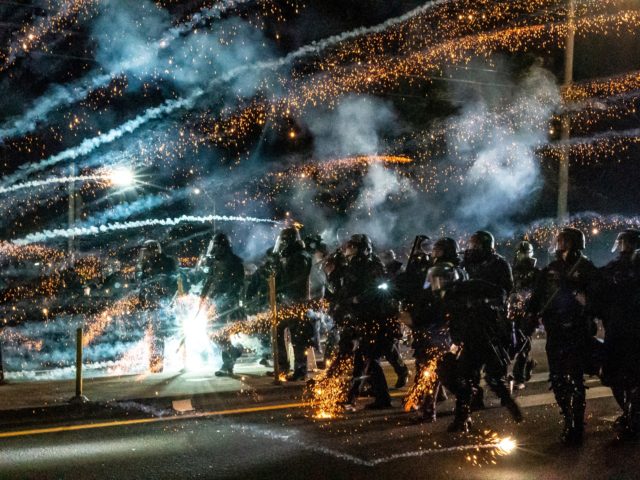 VANCOUVER WASH - SEPTEMBER 5: Oregon State Troopers and Portland police advance through tear gas and fire works while dispersing a protest against police brutality and racial injustice on September 5, 2020 in Portland, Oregon. Portland has seen nightly protests for the past 100 days following the death of George …