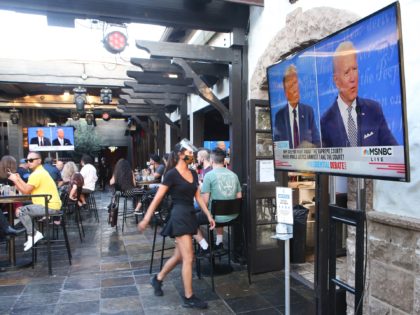 WEST HOLLYWOOD, CALIFORNIA - SEPTEMBER 29: People sit and watch a broadcast of the first debate between President Donald Trump and Democratic presidential nominee Joe Biden at The Abbey with socially distanced outdoor seating on September 29, 2020 in West Hollywood, California. The debate being held in Cleveland, Ohio is …