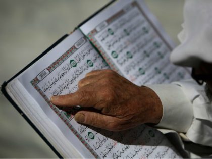A Palestinian man reads the Koran at the al-Omari mosque in Gaza City, on the second day o