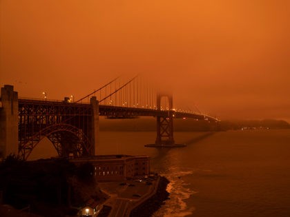 Cars drive along the Golden Gate Bridge under an orange smoke filled sky at midday in San Francisco, California on September 9, 2020. - More than 300,000 acres are burning across the northwestern state including 35 major wildfires, with at least five towns "substantially destroyed" and mass evacuations taking place. …