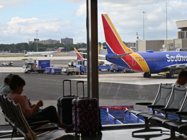 Passengers wait at the Southwest Airlines counter at Ronald Reagan Washington National Air