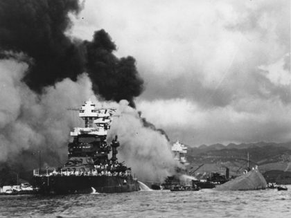 FILE - In this Dec. 7, 1941, file photo, part of the hull of the capsized USS Oklahoma is seen at right as the battleship USS West Virginia, center, begins to sink after suffering heavy damage, while the USS Maryland, left, is still afloat in Pearl Harbor, Oahu, Hawaii. Floyd …