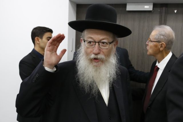 In this Feb. 23, 2020 file photo, Israeli Health Minister Yaakov Litzman arrives for a situation assessment meeting regarding the Coronavirus, in Tel Aviv, Israel. Housing Minister Yaakov Litzman, who served as health minister during the initial outbreak of the virus, resigned Sunday, Sept 13, 2020, in protest over the …