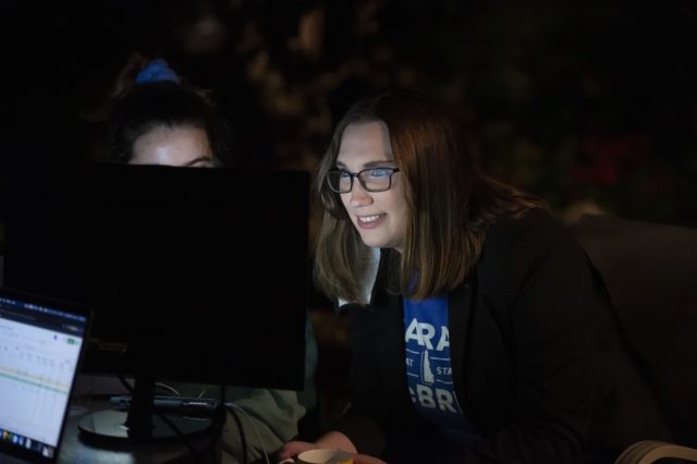 Transgender activist Sarah McBride, who hopes to win in the primary for the Delaware Senate, watches a computer screen at her watch party in Wilmington, Del., Tuesday, Sept. 15, 2020. (AP Photo/Jason Minto)