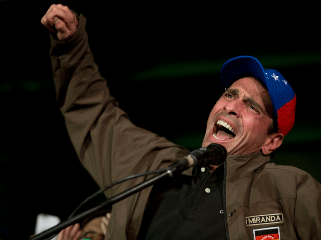 Venezuelan opposition leader Henrique Capriles speaks to supporters and reporters during a