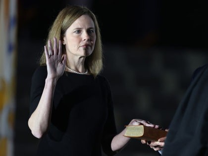 WASHINGTON, DC - OCTOBER 26: U.S. Supreme Court Associate Justice Amy Coney Barrett is sworn in by Supreme Court Associate Justice Clarence Thomas during a ceremonial swearing-in event on the South Lawn of the White House October 26, 2020 in Washington, DC. The Senate confirmed Barrett’s nomination to the Supreme …