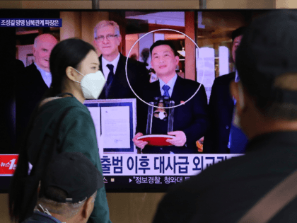 People watch a TV showing an image of Jo Song Gil, the North Korea's former ambassador to Italy, right, during a news program at the Seoul Railway Station in Seoul, South Korea, Wednesday, Oct. 7, 2020. Jo who had vanished in Italy in late 2018, currently lives in South Korea …