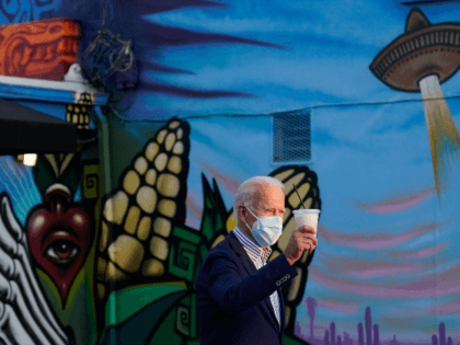 Democratic presidential candidate former Vice President Joe Biden holds a beverage as he leaves Barrio Cafe in Phoenix, Thursday, Oct. 8, 2020, during their small business bus tour. (AP Photo/Carolyn Kaster)