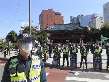 South Korean police officers wearing face masks and face shields stand guard to block protesters' possible rallies against the government in Seoul, South Korea, Friday, Oct. 9, 2020. Seoul city temporarily banned outdoor rallies with 10 or more people over infection risks against the spread of the coronavirus. (AP Photo/Ahn …