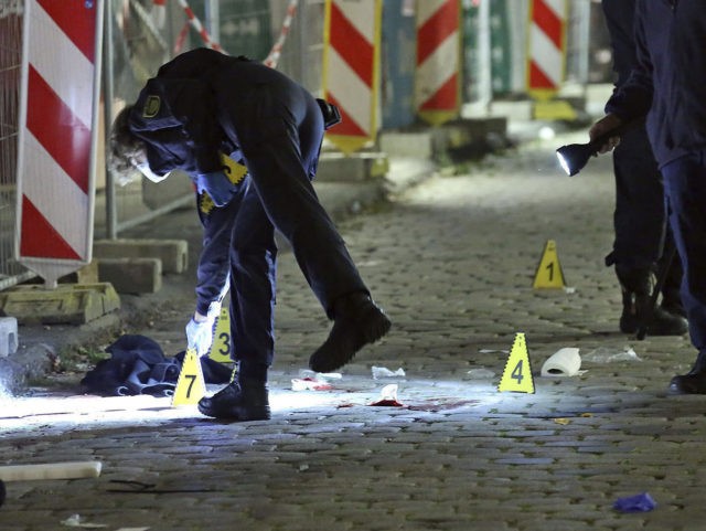 File---File picture taken Oct.5, 2020 shows criminal experts investigating a crime scene in Dresden, Germany. Two people died in a knife attack. The suspect that was arrested on Tuesday is known as a possible person in context of islamistic terrorists. (Roland Halkasch/dpa via AP, file)