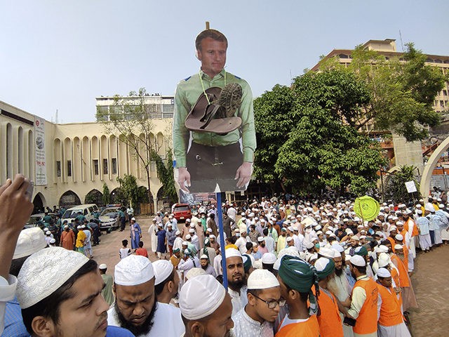 Supporters of Islami Andolan Bangladesh, an Islamist political party, carry a cutout of French President Emmanuel Macron with a garland of footwear around it as they protest against the publishing of caricatures of the Prophet Muhammad they deem blasphemous, in Dhaka, Bangladesh, Tuesday, Oct. 27, 2020. Muslims in the Middle …