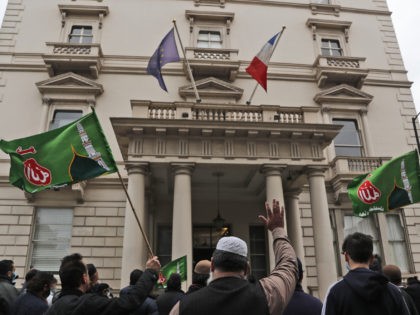 Protesters gather at the French embassy in London, Friday, Oct. 30, 2020 to protest agains