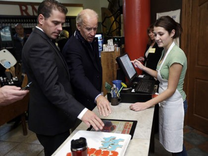 Vice President Joe Biden, accompanied by his son Hunter Biden places an order for a blue Democratic donkey cookies during a visit to the Red Mug Friday, Nov. 2, 2012, in Superior, Wis. (AP Photo/Matt Rourke)