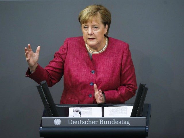 German Chancellor Angela Merkel delivers her speech during a debate about her policy as pa